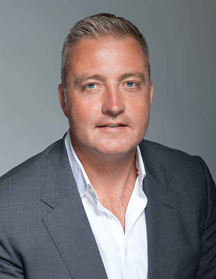 Professional man in business attire getting corporate headshot in NYC studio